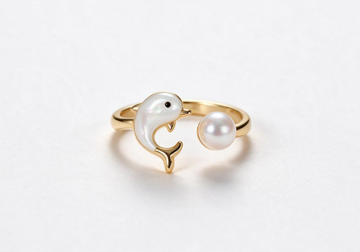 Gold-plated brass dolphin-shaped ring with a delicate pearl accent
