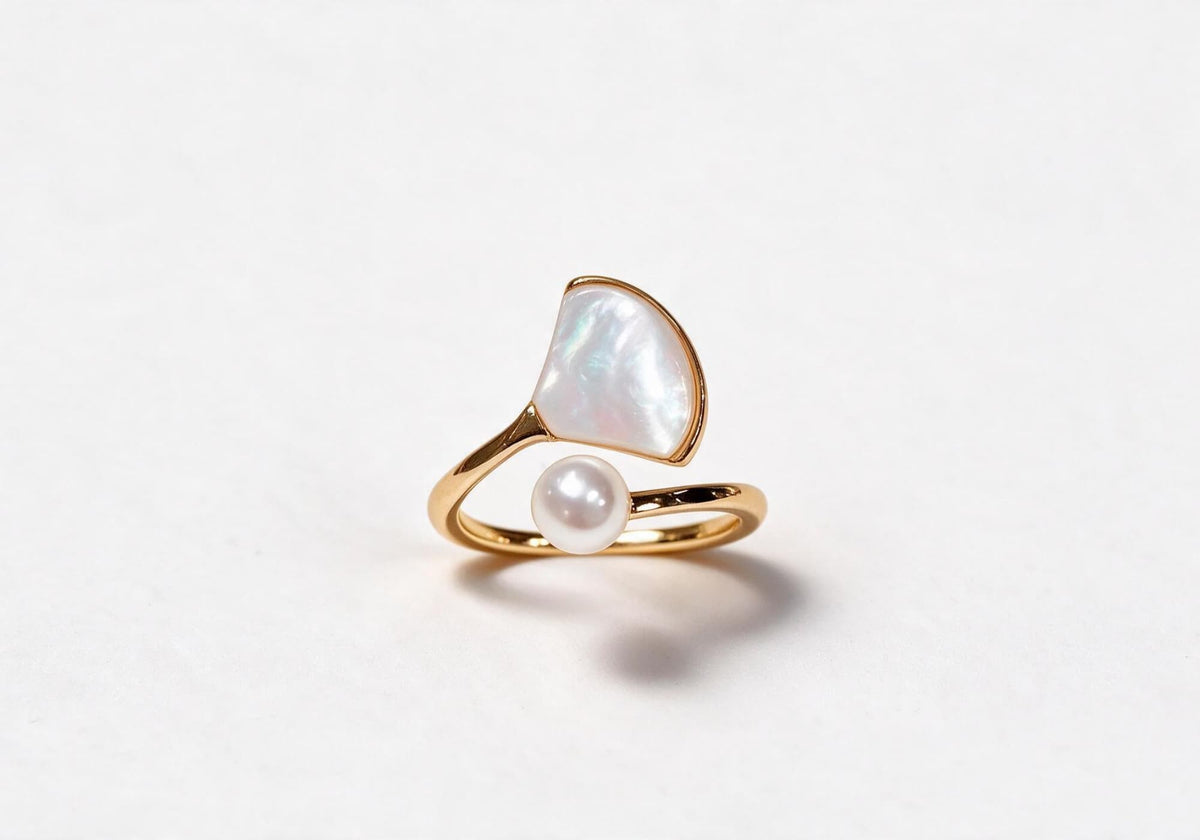 Gold-plated brass ring featuring a detailed ginkgo leaf design and a delicate pearl accent