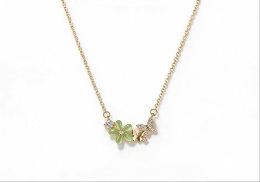 Gold-plated necklace featuring a green gemstone flower and a zirconia-encrusted butterfly