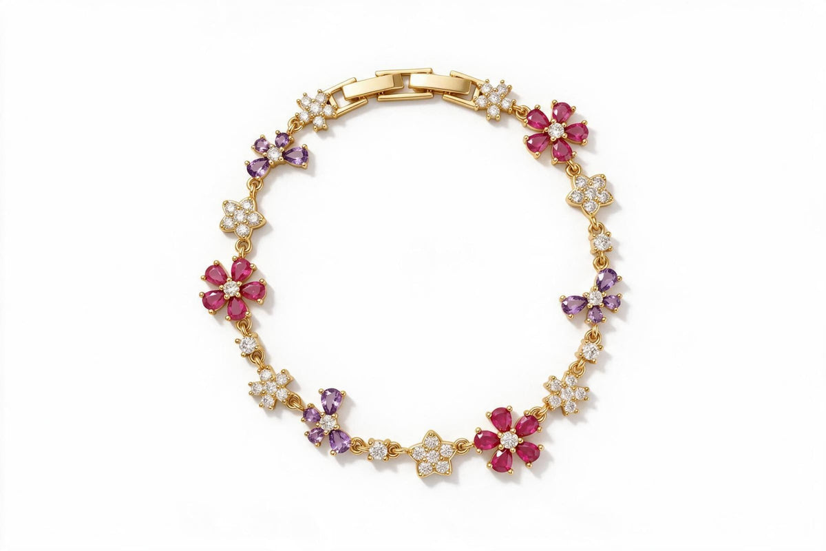 MAROVA JEWELS gold-plated floral charm bracelet adorned with alternating pear-cut red cubic zirconia flower motifs, purple four-petal CZ flowers and pavé CZ blossom stations, linked by delicate chain with a polished H-clasp, luxury fashion jewelry on clean white background