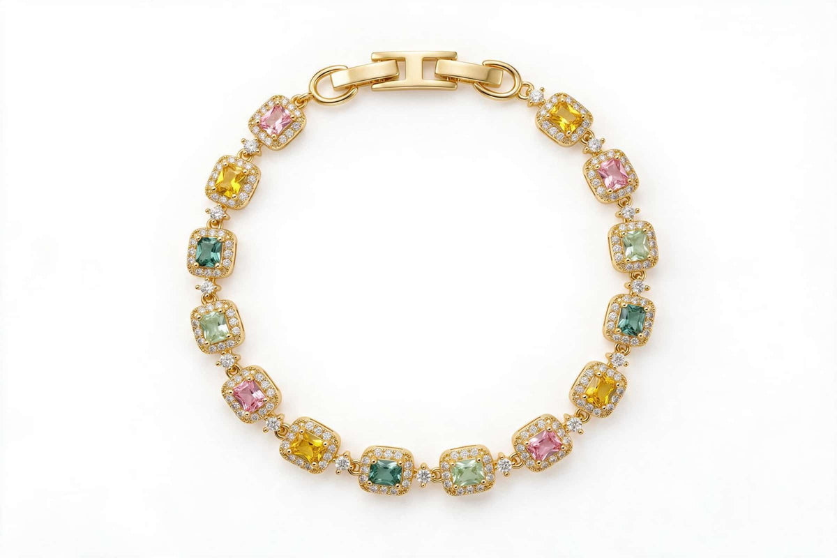 MAROVA JEWELS gold-plated tennis bracelet with alternating emerald-cut cubic zirconia stones in pink, yellow and green shades, each framed by a brilliant cubic zirconia halo, secured with a polished H-clasp, vibrant luxury fashion jewelry on white backdrop