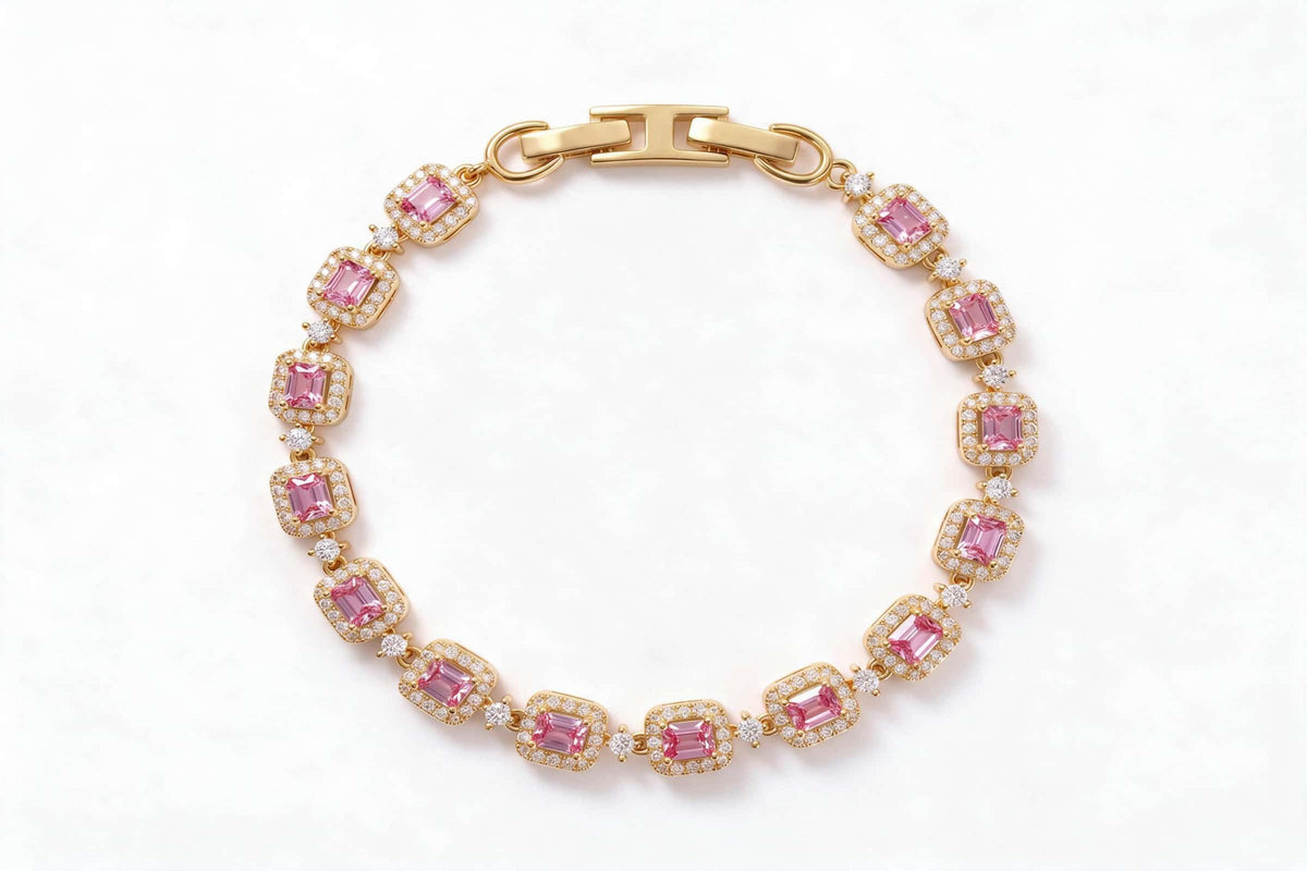 MAROVA JEWELS gold-plated tennis bracelet featuring emerald-cut pink cubic zirconia stones encircled by sparkling cubic zirconia halos, connected by delicate CZ stations, finished with a sleek H-shaped clasp, luxury fashion jewelry on clean white background