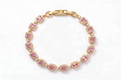 MAROVA JEWELS gold-plated tennis bracelet featuring emerald-cut pink cubic zirconia stones encircled by sparkling cubic zirconia halos, connected by delicate CZ stations, finished with a sleek H-shaped clasp, luxury fashion jewelry on clean white background