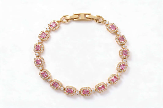 MAROVA JEWELS gold-plated tennis bracelet featuring emerald-cut pink cubic zirconia stones encircled by sparkling cubic zirconia halos, connected by delicate CZ stations, finished with a sleek H-shaped clasp, luxury fashion jewelry on clean white background