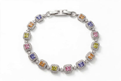  MAROVA JEWELS platinum-plated tennis bracelet with a rainbow array of emerald-cut cubic zirconia stones in purple, orange, yellow and pink, each accented by a dazzling cubic zirconia halo, fastened with a polished H-clasp, colorful luxury fashion jewelry on clean white background
