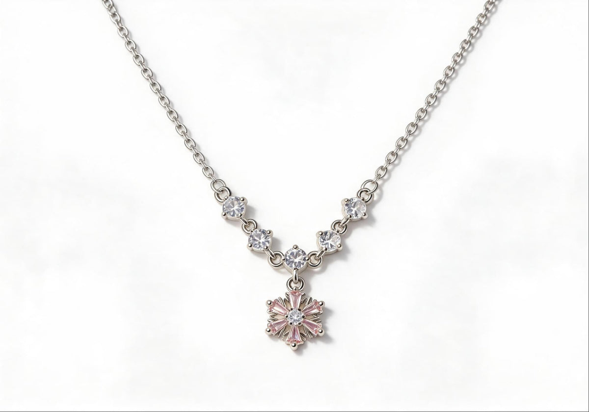 White gold-plated necklace featuring five pink gemstones and a zirconia jasmine flower