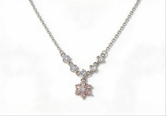 White gold-plated necklace featuring five pink gemstones and a zirconia jasmine flower