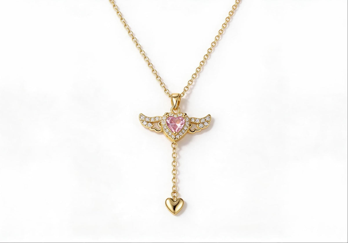 Gold winged heart pendant necklace with zirconia stones
